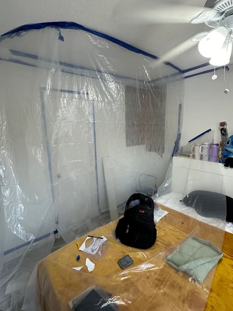 Bedroom sealed off with plastic sheeting and painter's tape before remodeling work begins